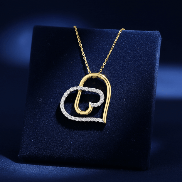 9ct Yellow Gold 110 Carat Diamond Heart Pendant displayed on blue velvet background showcasing elegant design.