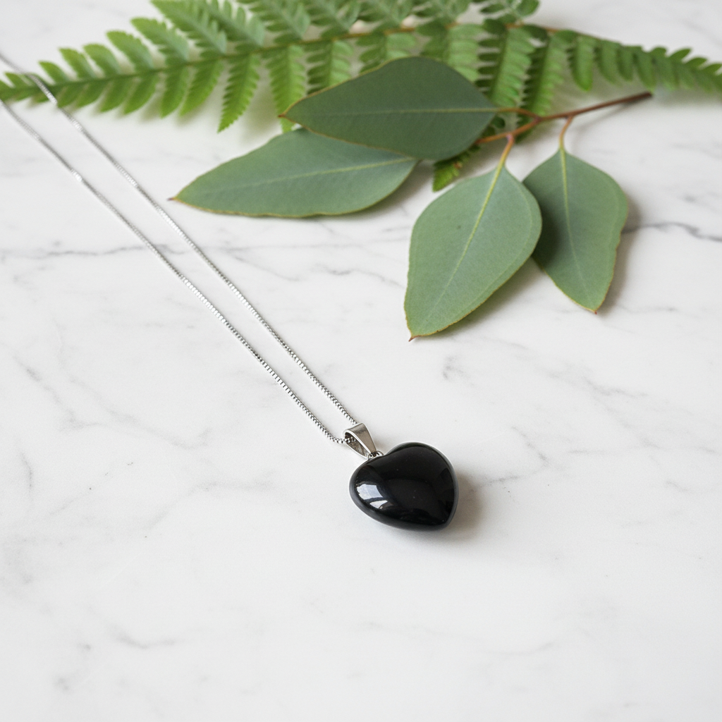 Black Obsidian Necklace on White Marble with Greenery