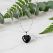 Black Obsidian Necklace on White Marble with Greenery