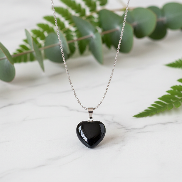Black Obsidian Necklace on White Marble with Greenery