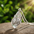 Clear shell charm close-up with single chain - v3