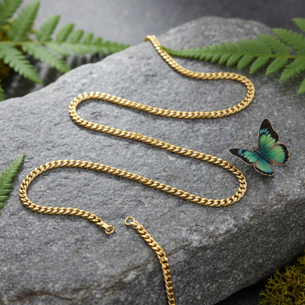 Complete gold chain on rock with butterfly and greenery