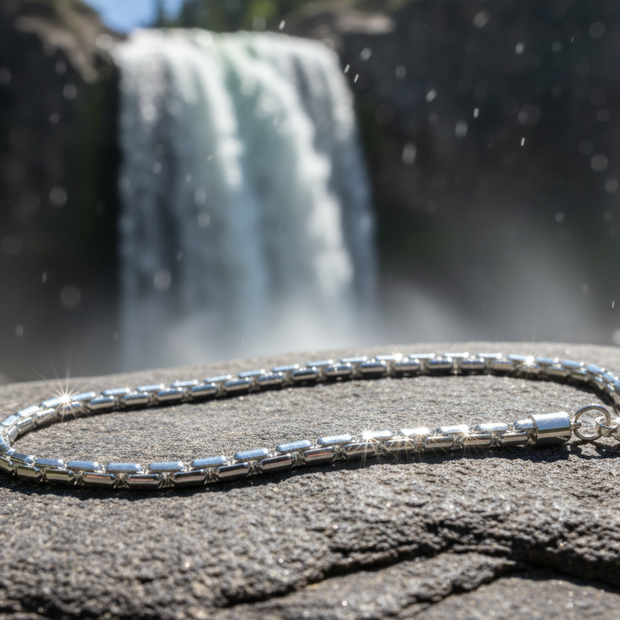 Complete sterling silver figaro chain bracelet near waterfall with sparkle