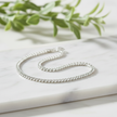 Detailed sparkling silver bracelet on marble