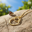 Double circle gold pendant alternative view with butterfly