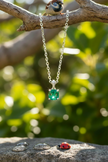 Emerald pendant with sparrow on branch