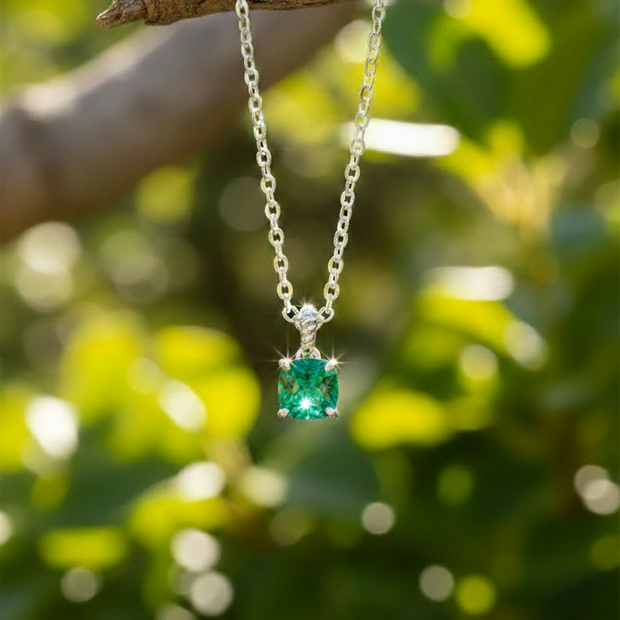 Emerald pendant with sparrow on branch