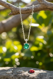 Emerald pendant with water droplets on rock