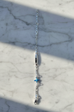 Enhanced sterling silver figaro chain bracelet on natural stone background
