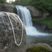 Figaro chain with enhanced sparkle beside waterfall