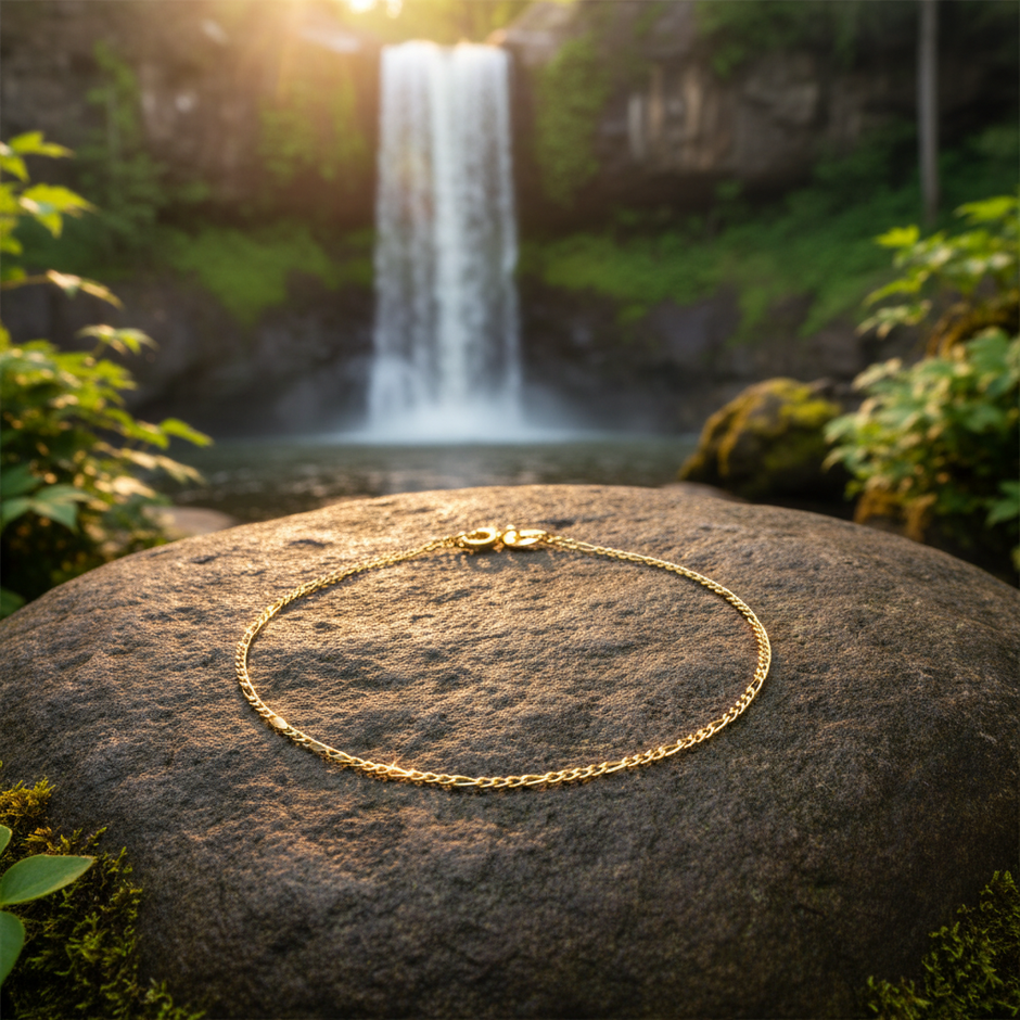 Gold bracelet on rock with waterfall background