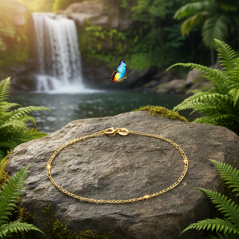 Gold bracelet with butterfly flying past and waterfall