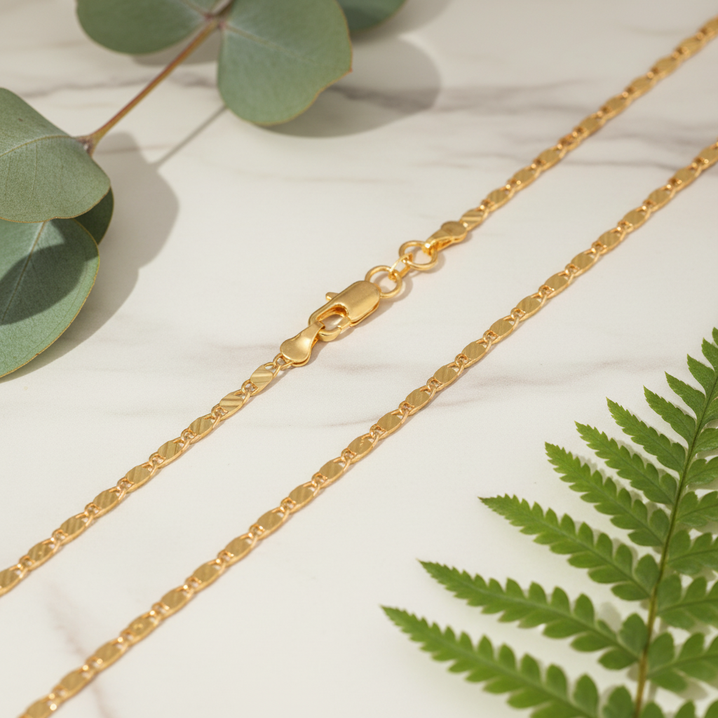 Gold Chain Detail on Marble with Greenery