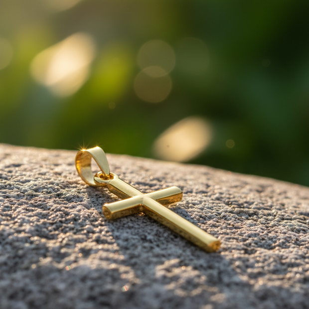 Gold cross on rock with green background, no chain