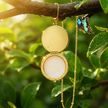 Gold lip balm locket with butterfly and enhanced reflection
