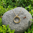 Gold necklace with balanced sparkle and two bull ants