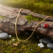 Gold Necklace with Ladybug on Wood
