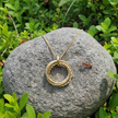 Gold necklace with natural realistic lighting and two bull ants