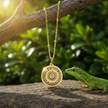 Gold sunburst pendant with lizard climbing branch