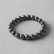 Hematite Bracelet Overhead on Concrete