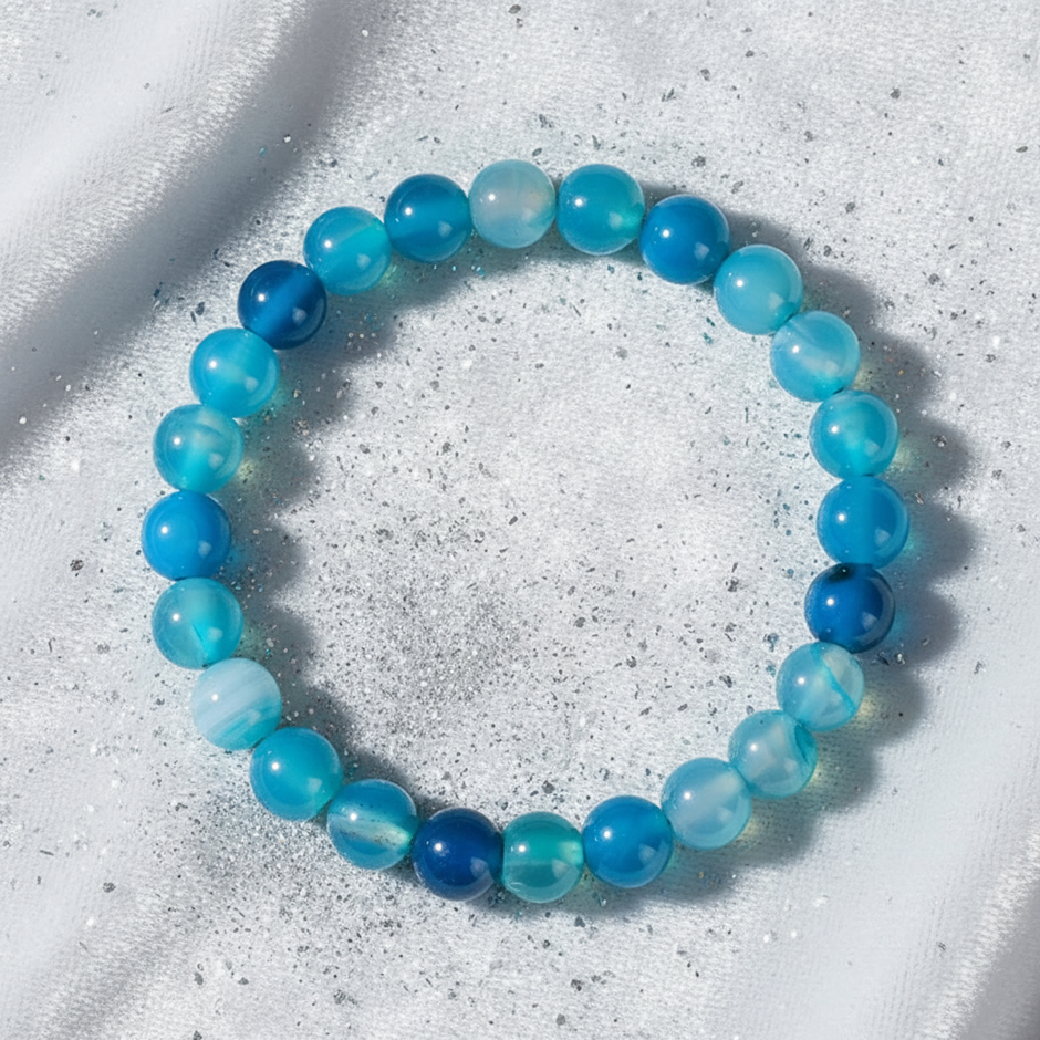Natural 8mm Blue Agate crystal stone bracelet on white velvet with silver dust