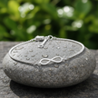 Infinity Bracelet on Rock with Water Droplets