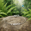 Infinity bracelet with full chain in focus and butterfly