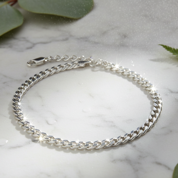 Italian 925 sterling silver curb chain bracelet with overhead sunlight sparkle, water mist and greenery