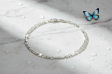 Italian sterling silver figaro bracelet on marble with water drops and butterfly