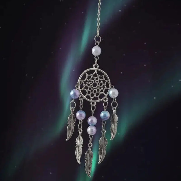 mystic dream catcher with aurora beads hanging against a dark, ethereal background resembling the northern lights.