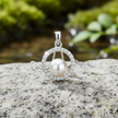 Pearl pendant front view on rock - sparkling