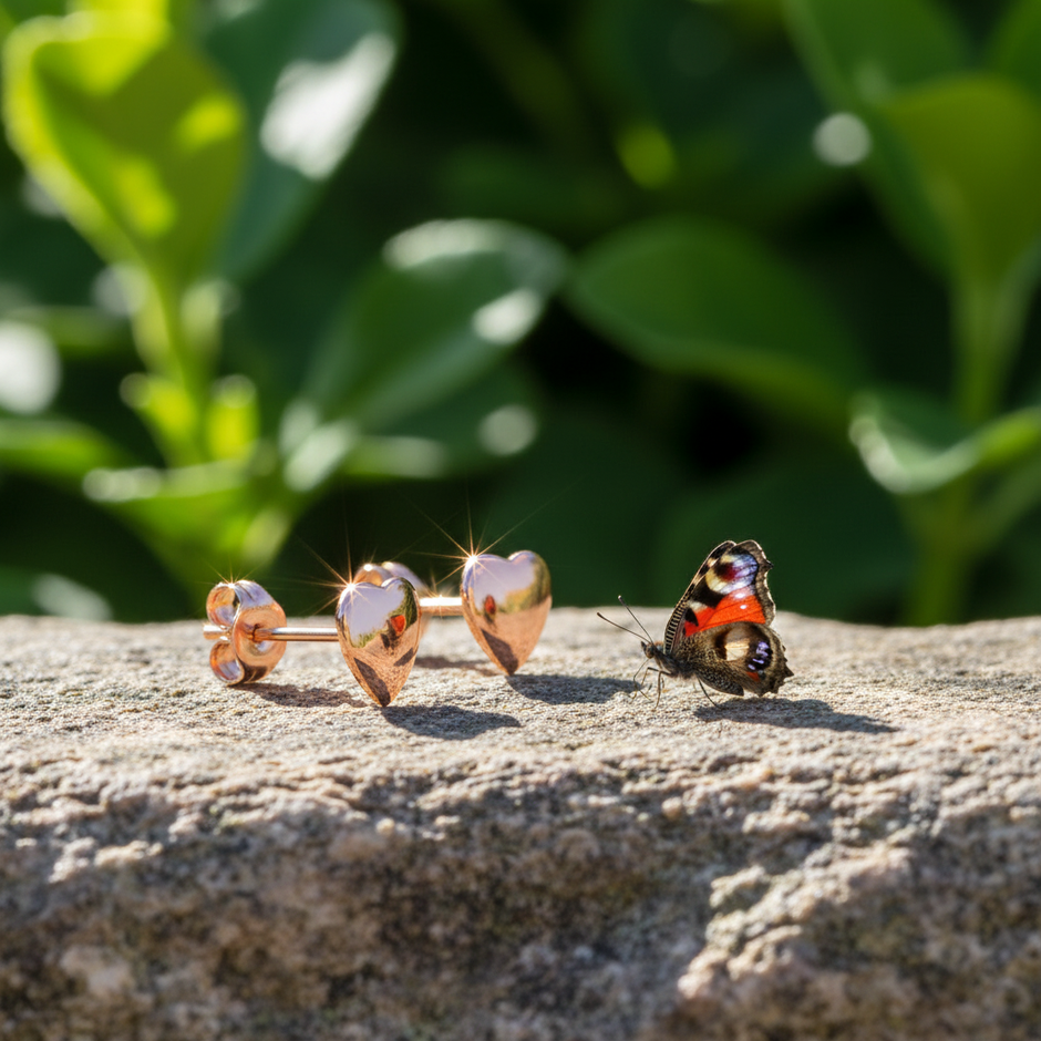 Rose gold heart earrings side view showing backs