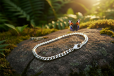 Silver bracelet on rock with butterfly