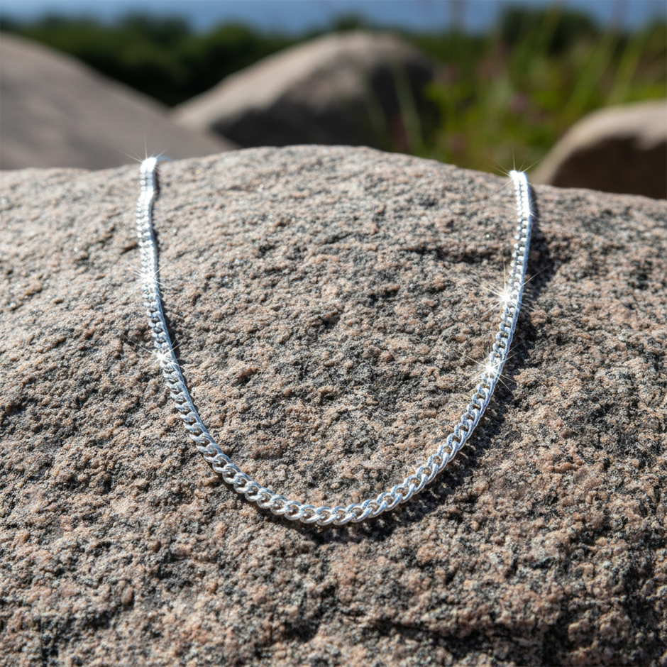 Silver chain laid flat on rock surface