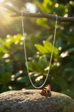 Silver chain with butterfly on rock