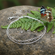 Silver double-strand anklet with butterfly, greenery, and dew drops