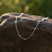 Single silver chain on rock