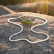 Single silver curb chain with clasp on rock