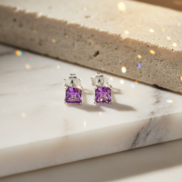 Sterling Silver Amethyst Stud Earrings with Sunlit Sparkle on Natural Background