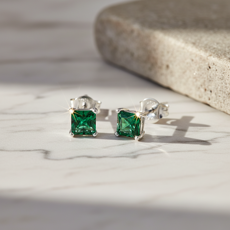 Sterling Silver Emerald Green Cubic Zirconia Stud Earrings with Sparkle on Natural Background