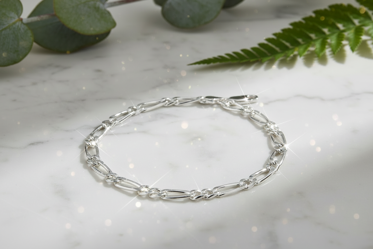 Sterling silver figaro chain bracelet with direct sunlight and intense sparkle