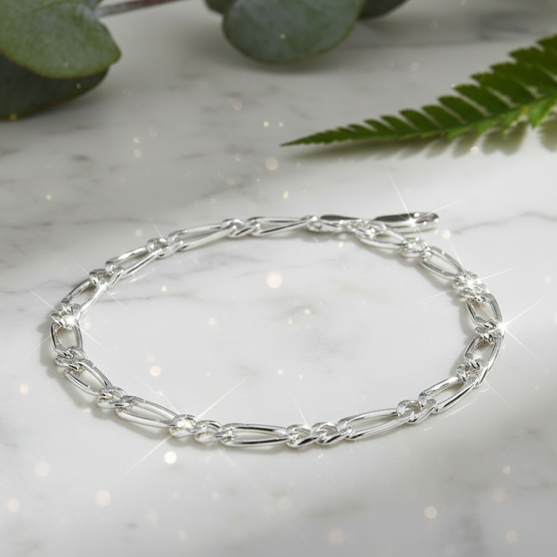 Sterling silver figaro chain bracelet with direct sunlight and intense sparkle