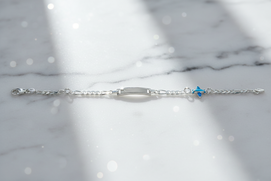 Sterling silver figaro chain bracelet with dramatic sparkle on marble background