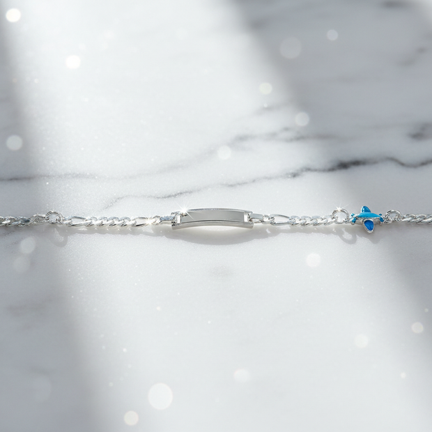 Sterling silver figaro chain bracelet with dramatic sparkle on marble background