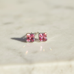 Sterling Silver Pink Cubic Zirconia Stud Earrings Angled View with Sparkle