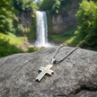 Two-Tone Cross Pendant on Rock with Waterfall