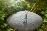 White gold aquamarine pendant facing forward with natural sparkle