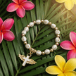 White & Gold Cross Bead Angel Wing Cross Charm Stretch Bracelet - DP Online